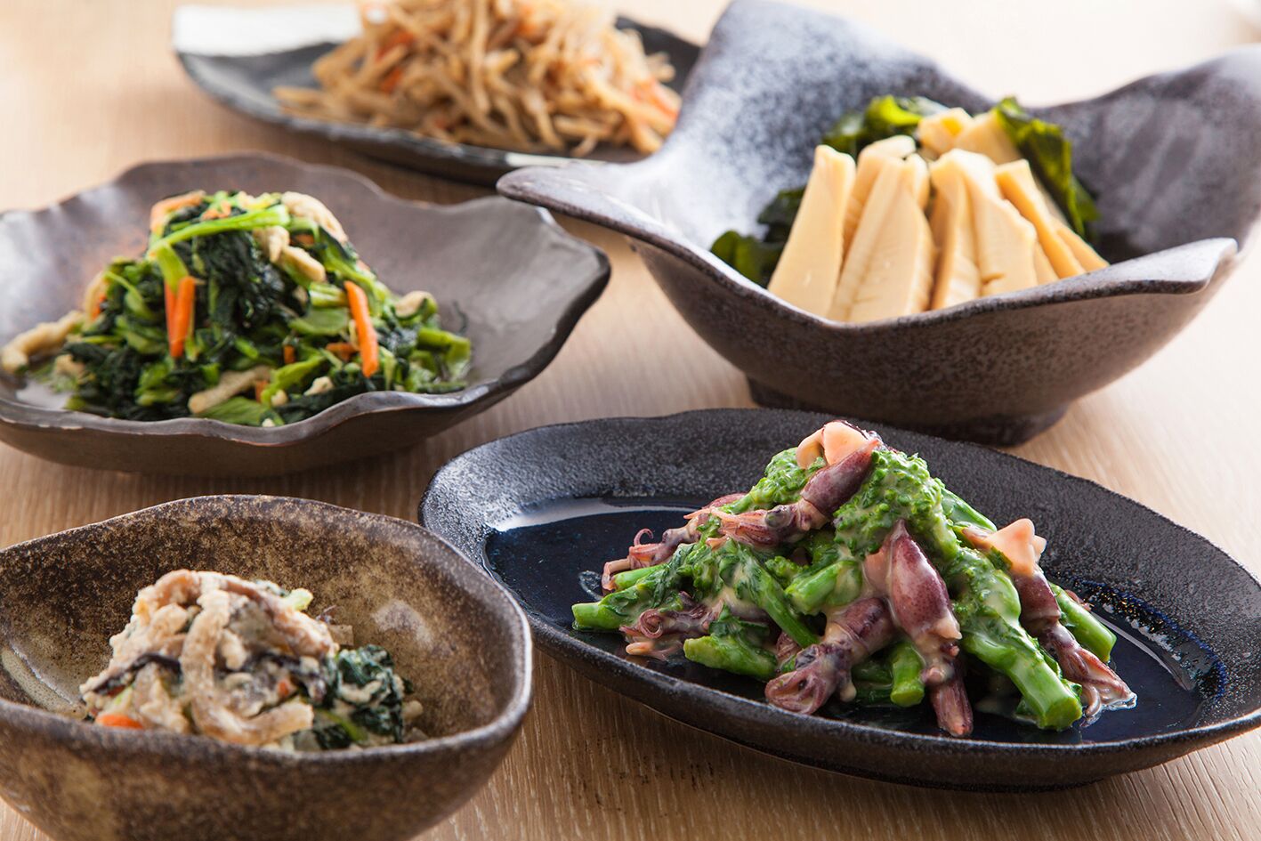 A variety of dishes on a wooden table.