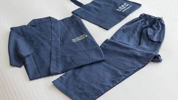 A set of blue clothing items including a shirt, pants, and a drawstring bag, all with the text "SAKURA TERRACE" on them.