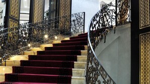A grand staircase with ornate metal railings and red carpeted steps. - Hotel Chams (Tetouan)