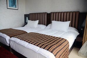 Sengetøy av topp kvalitet, minibar og safe på rommet