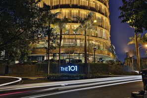 A modern building with a prominent sign reading "THE101" at night.