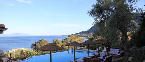 Seasonal outdoor pool, open 9 AM to 9 PM, pool umbrellas, pool loungers