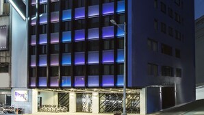 A modern hotel with a grid of rooms, a prominent sign, and a covered entrance. - The Cloud Hotel Taichung (Taichung)