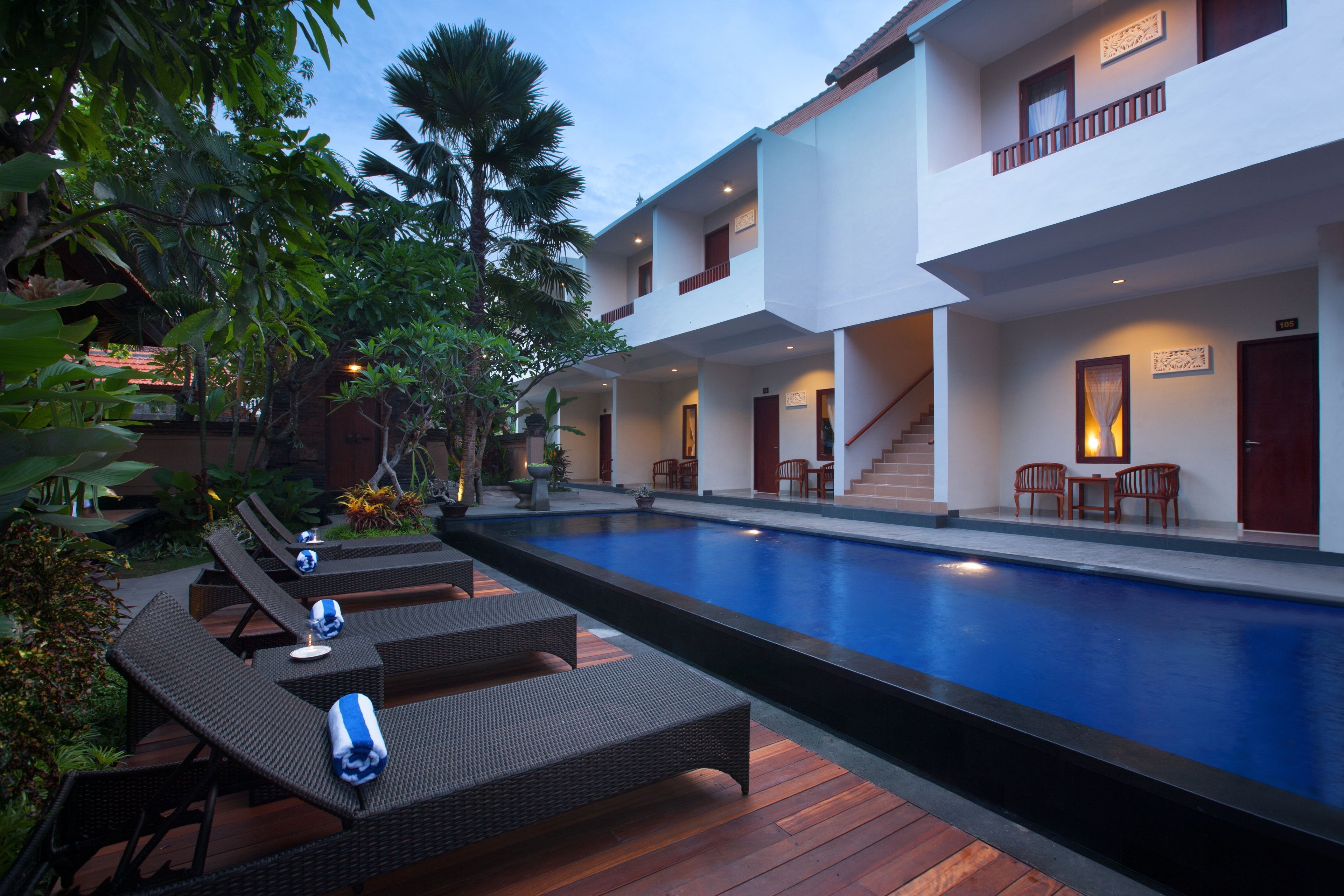 A poolside area with lounge chairs and a swimming pool.