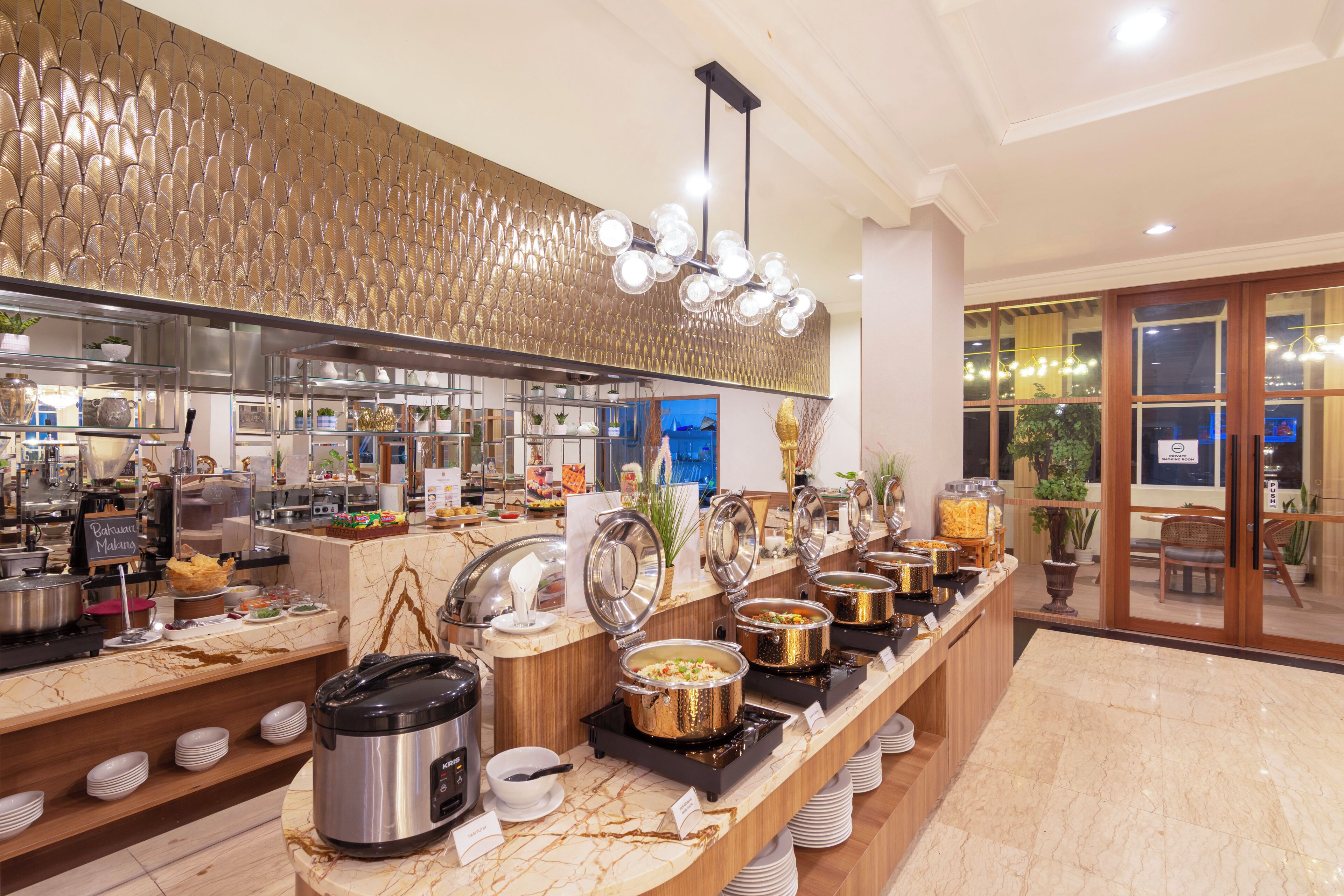 A buffet area with various food stations, including a rice cooker and a hot pot.
