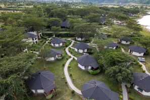 A residential area with multiple houses, each with a dark roof and surrounded by greenery. - Sentrim Elementaita Lodge (Gilgil)
