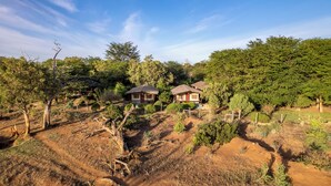 A rural property with two cabins surrounded by dense forest. - Sentrim Tsavo Lodge (Voi)