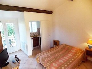Enjoy a peaceful retreat with a comfortable bed, desk, and chair, offering a serene view of the outdoors.