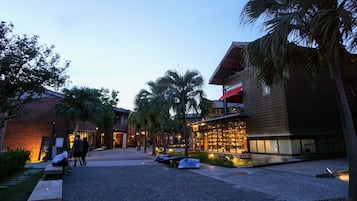 A building with a modern design, featuring a glass facade and a red roof.