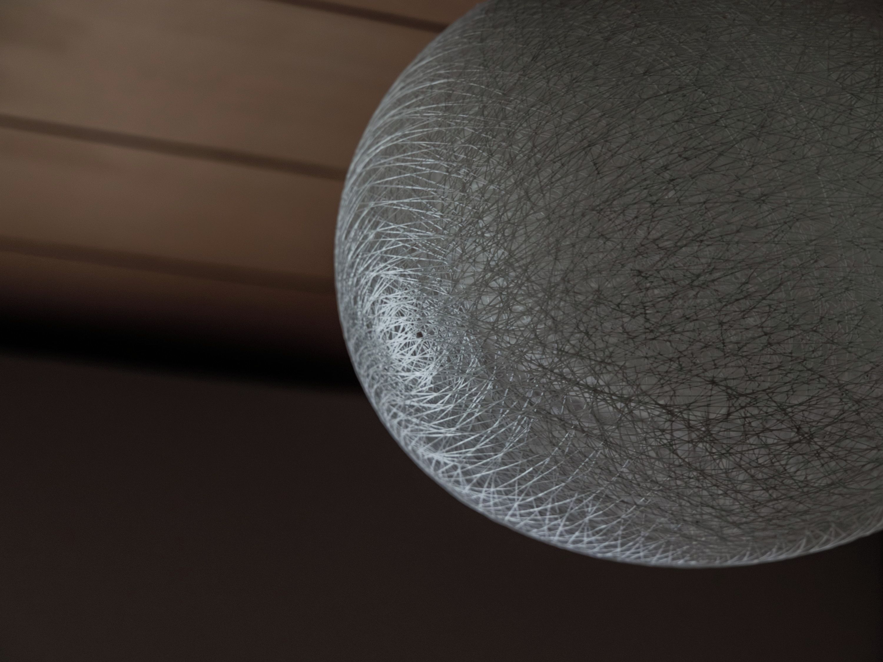 Un objet sphérique à la surface texturée, qui pourrait être un élément décoratif ou une partie d’une structure.