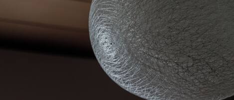A spherical object with a textured surface, possibly a decorative item or part of a structure.