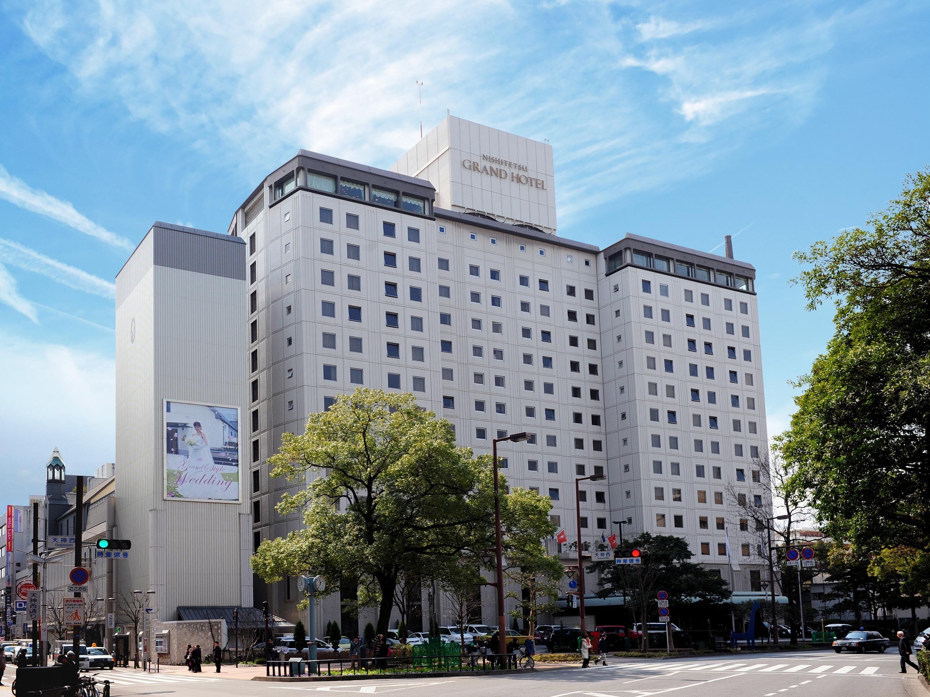 A multi-story hotel with a prominent sign for the Grand Hotel.