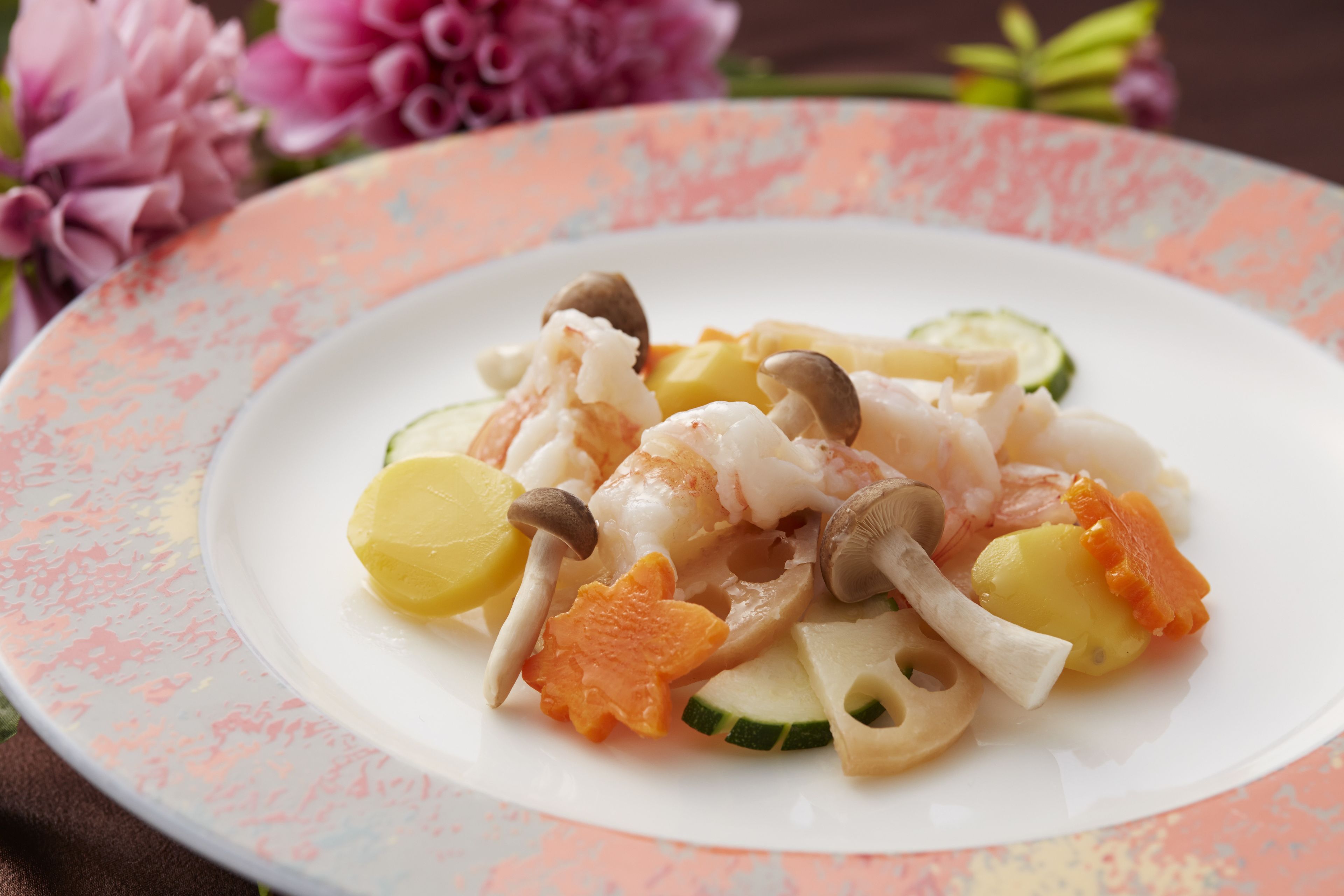 A plate of food with shrimp, mushrooms, and vegetables.