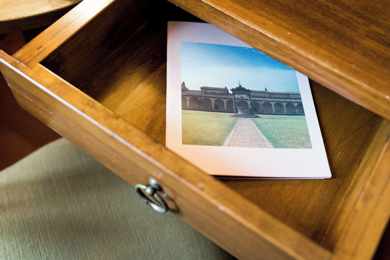 A wooden drawer with a photograph of a building.