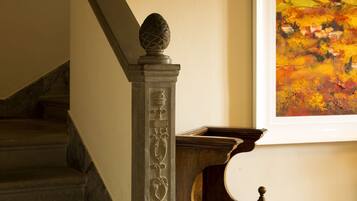 Un escalier orné d’une balustrade décorative et d’un tableau accroché au mur.