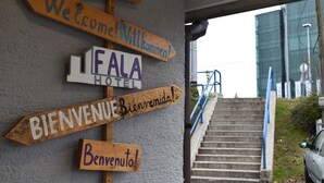 A wooden signpost with multiple welcome signs in different languages, including "Welcome!" and "Bienvenido!" - Hotel Fala (Zagreb)