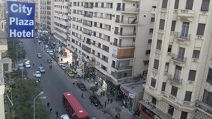 A multi-story building with balconies and a sign for City Plaza Hotel. - City Plaza Hostel (Cairo)