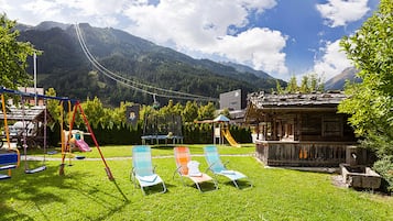 Escape to a serene mountain retreat with swings, slides, and a peaceful gazebo.