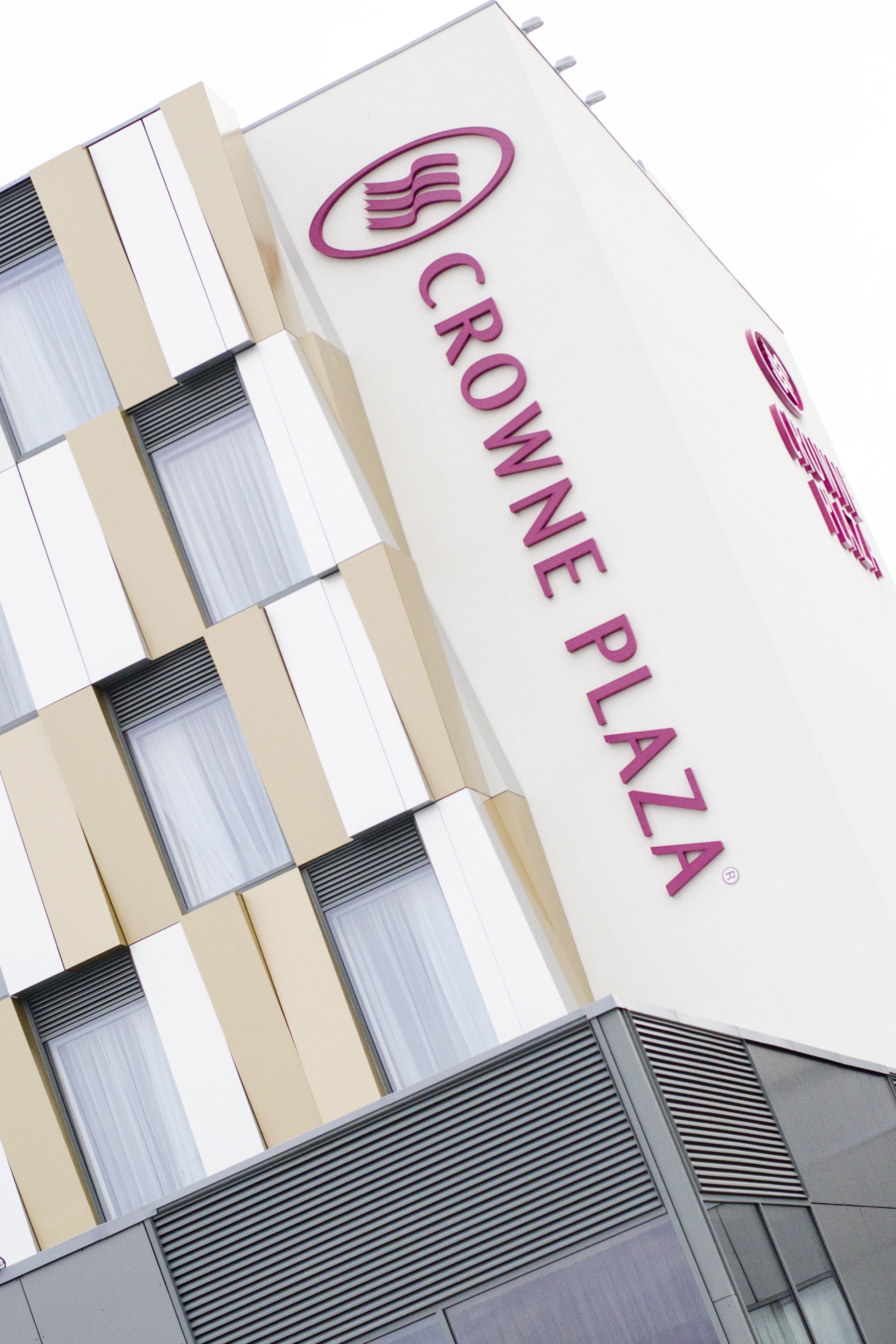 A building with the sign "CROWNE PLAZA" indicating a commercial property.