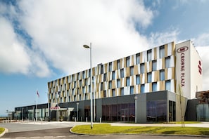 A modern hotel building with a geometric facade, large windows, and a prominent signage for 'Crown Plaza'. - Crowne Plaza Aberdeen Airport by IHG (Aberdeen)