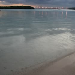 On the beach, white sand, sun-loungers, beach towels