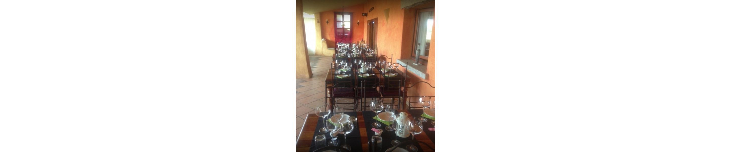 A dining area with multiple tables set for service, a tiled floor, and a view of the outside through a window.