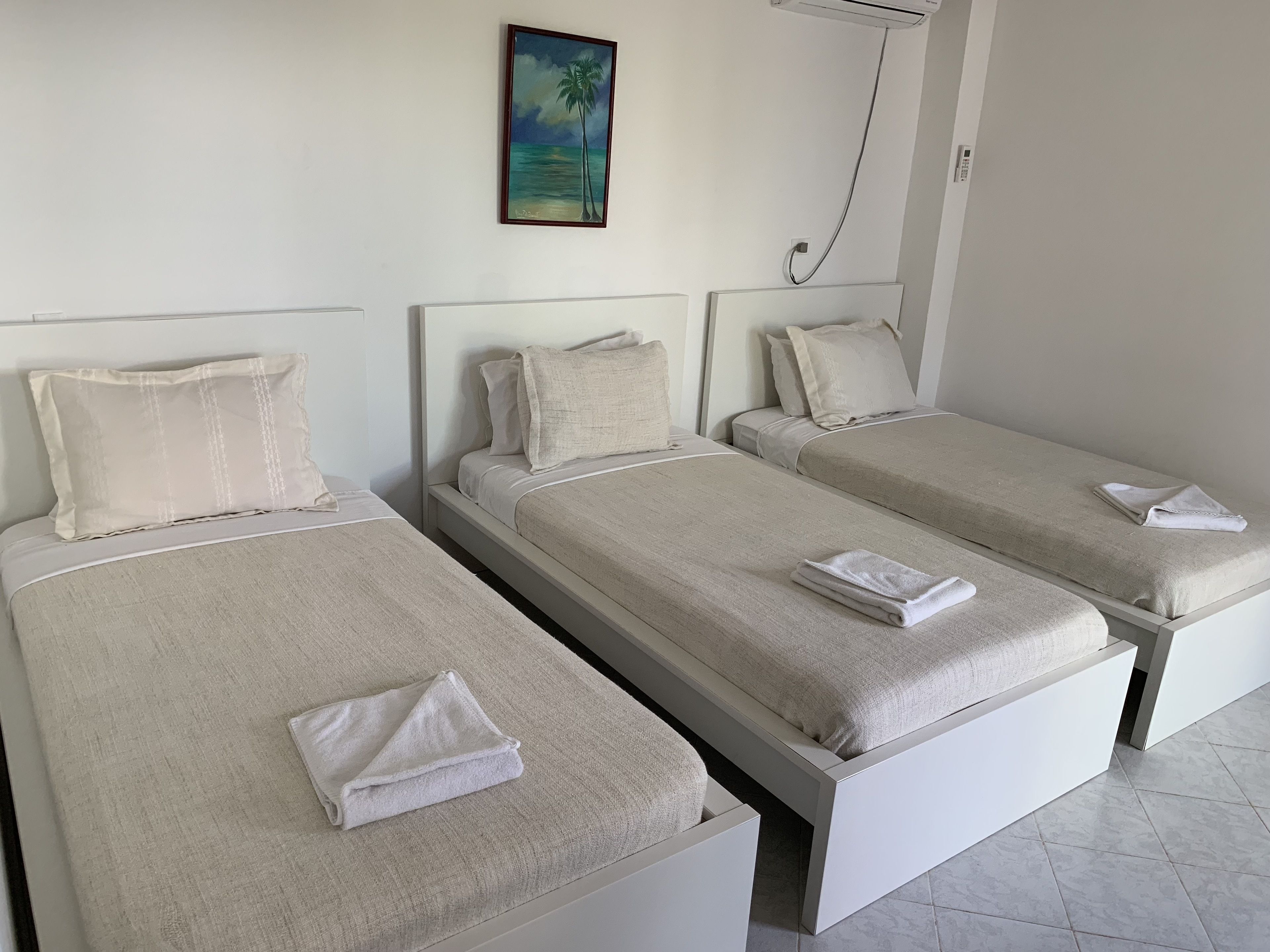 triple room, 3 single beds, partial ocean view | in-room safe, desk, bed sheets