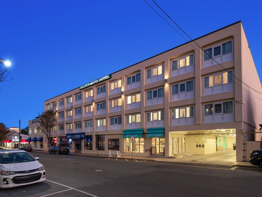 A multi-story hotel with a flat facade, multiple balconies, and a ground-level entrance.
