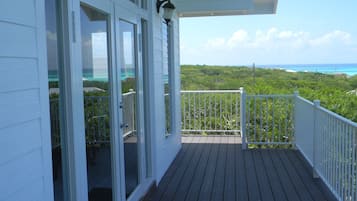 Enjoy the serene ocean views from this deck with a lush landscape backdrop.