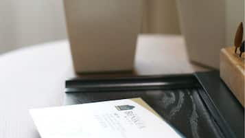 A close-up of a white card with text and a logo, placed on a black surface, possibly a table or desk.