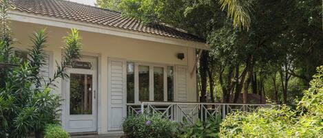 A building with a tiled roof, a porch with a railing, and a sign that reads "Combined Spa."