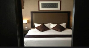 Minibar, desk, blackout curtains, iron/ironing board