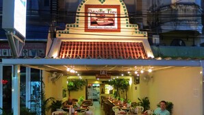 A restaurant with a tropical theme, featuring a signboard with 'Paradise Inn' and 'Great Room, China Food'. - Paradise Inn (Karon)