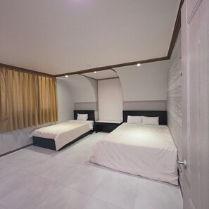 A hotel room with two beds, a curved ceiling, and a large window with curtains. - Island Motel (Yeosu)