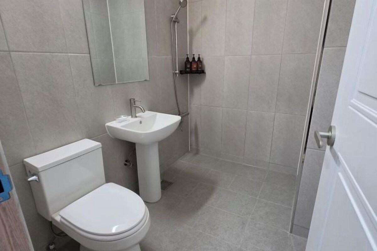 Shower, hair dryer, slippers, towels