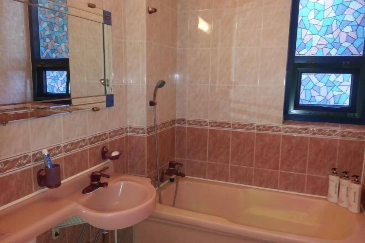 Bathroom | Shower, hair dryer, slippers, towels