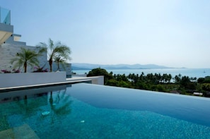 Outdoor pool, an infinity pool, pool loungers