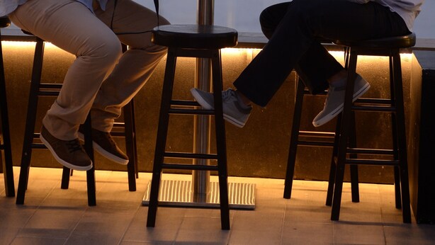 Two men seated at a table with drinks, overlooking a cityscape. - Three ONine Urban House (Beirut)
