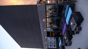 A modern building with a sloped roof and a glass facade. - Three ONine Urban House (Beirut)