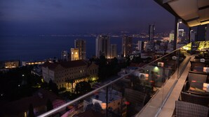 A cityscape at dusk with a view of the waterfront and high-rise buildings. - Three ONine Urban House (Beirut)