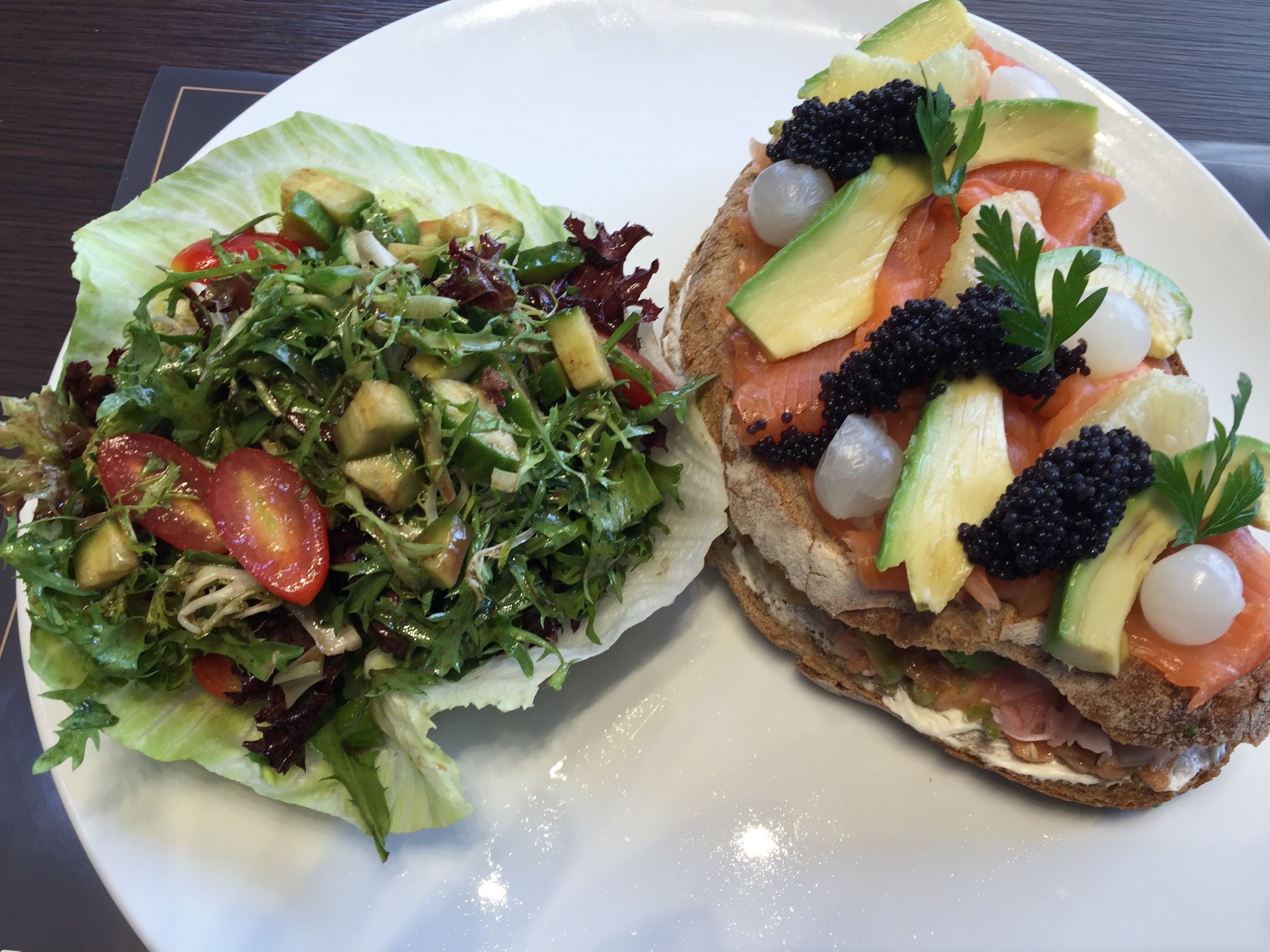 A plate with two sandwiches and a salad.
