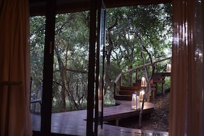 Luxury Suite | Living room | 50-inch Smart TV with satellite channels, TV, fireplace - AM Lodge (Hoedspruit)