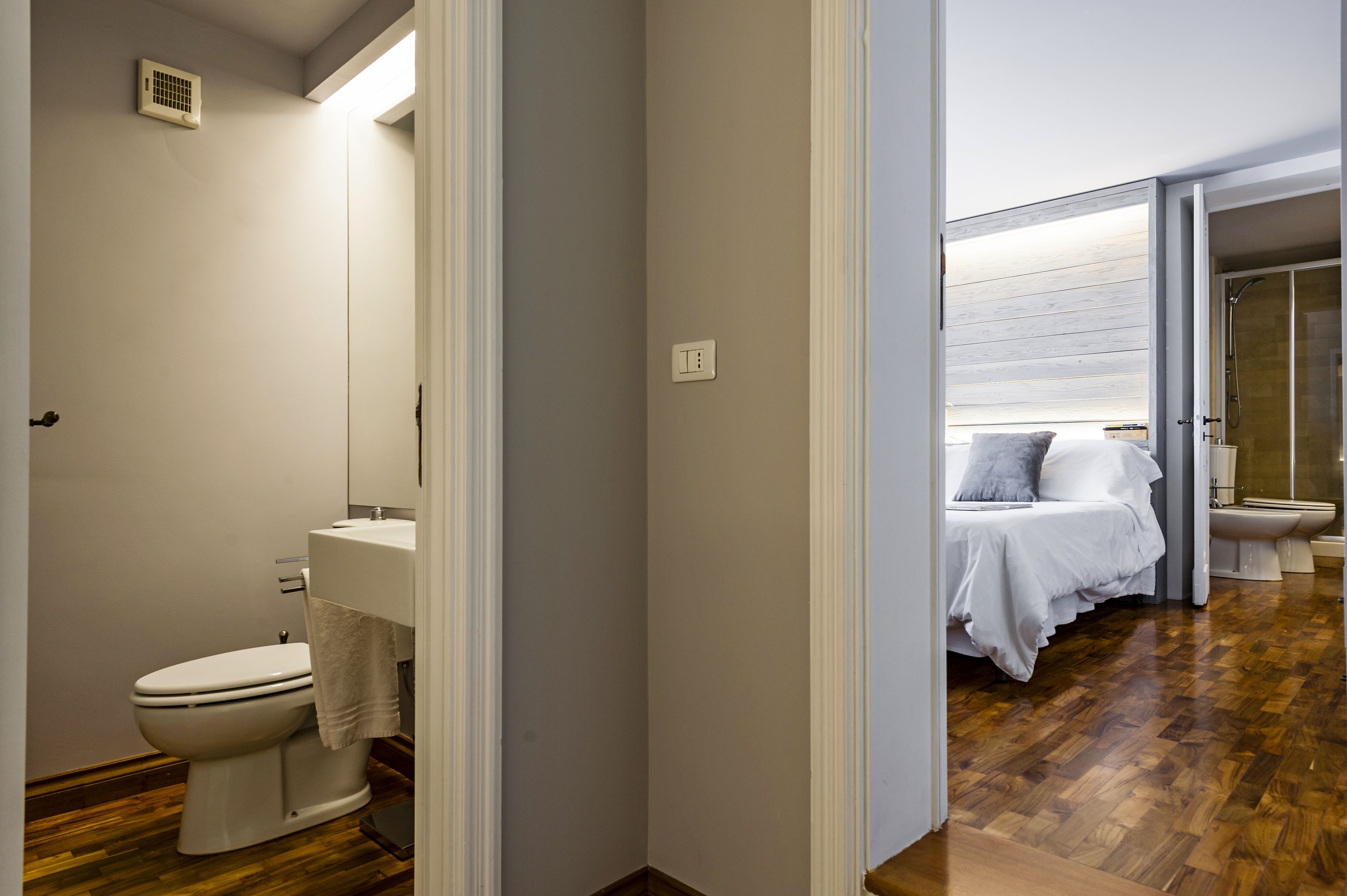 A modern bathroom with a toilet, sink, and shower.