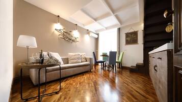 Apartamento Deluxe, 2 habitaciones | Zona de estar | Televisión de pantalla plana de 32 pulgadas con canales por satélite