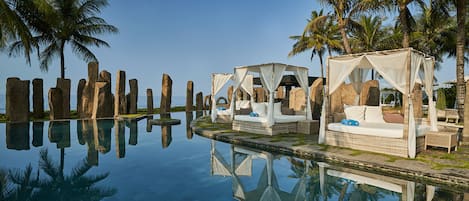 Outdoor pool, open 7:00 AM to 7:00 PM, free cabanas, pool umbrellas
