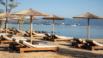 On the beach, sun-loungers, beach umbrellas