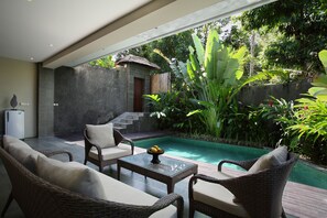 A modern outdoor pool area with wicker furniture and a thatched-roof structure. - The Canggu Boutique Villas (Tibubeneng)
