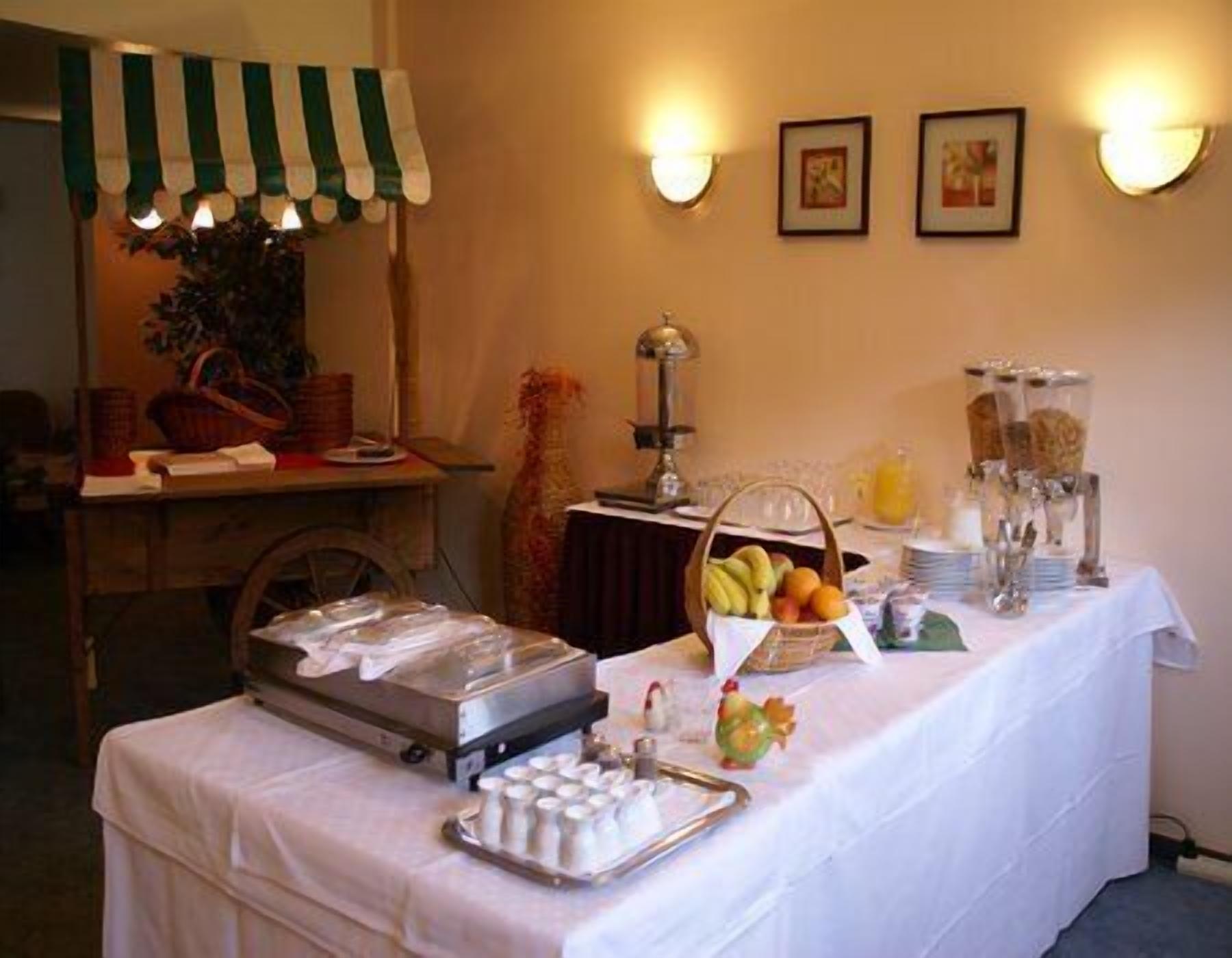 A buffet setup with various food items and a coffee station.