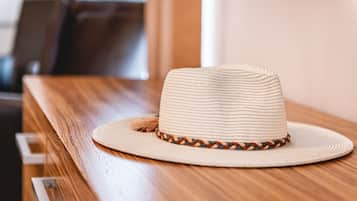 A straw hat with a braided band on a wooden table.