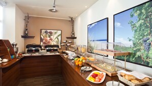 A breakfast buffet with various food items, a coffee station, and a large window with a vineyard view. - Casino & Hotel ADMIRAL Kozina (Hrpelje-Kozina)
